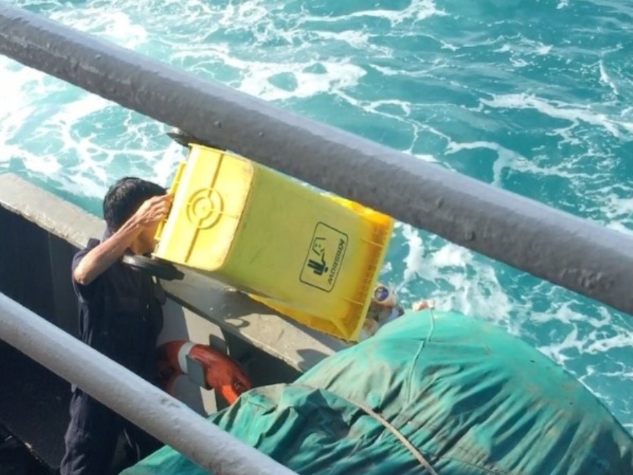 Petugas Kebersihan Buang Sampah di Laut