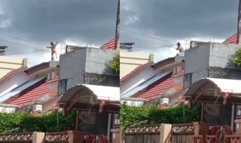 Biar Gak Bosan Pria ini Lakukan Gerakan Pemanasaan Ketika Berjemur di Atap Rumah