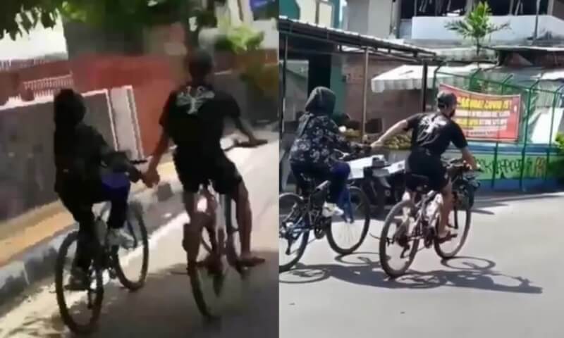 Romantis Tapi Bahaya Sepasang Pesepeda Asyik Gowes Sambil Gandengan Tangan