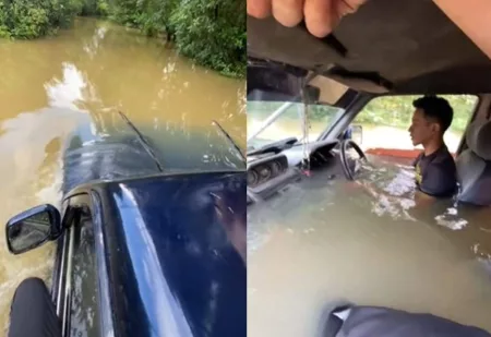 Momen Pria Kendarai Mobil di Jalan yang Banjir, Santuy Walau Badan Terendam Air